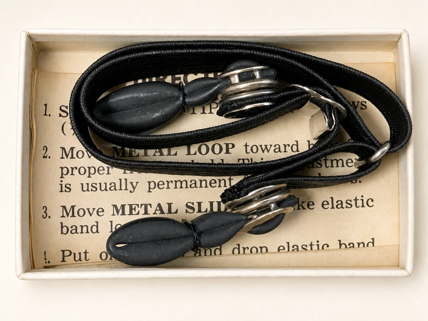 Restored archival photograph of an original Glass-Gard eyeglass holder preserved inside its box